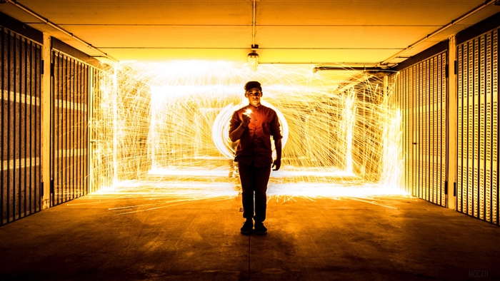 Man with fire sparks in a garage