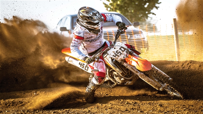 Motocross rider drifting on dirt track 4K
