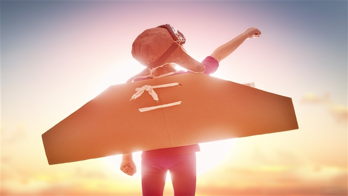 Girl with cardboard wings and aviator hat