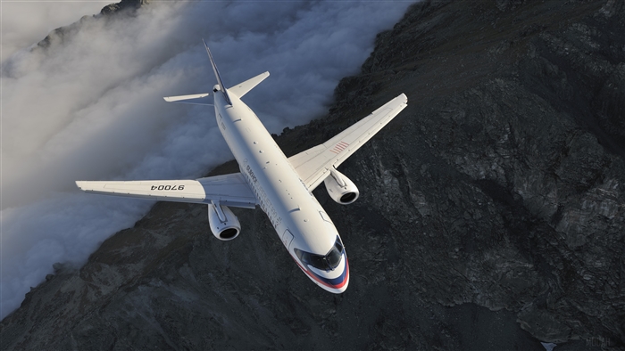 Sukhoi Superjet 100 passenger airplane flying over mountains