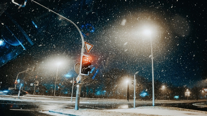 Traffic light in snow at night 4K