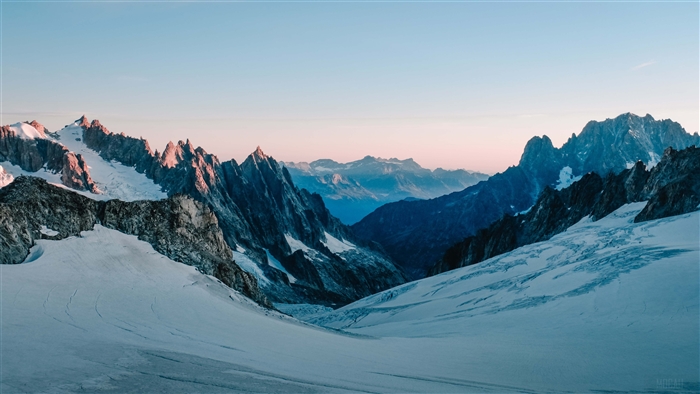 Snow-covered mountains at sunrise 4K