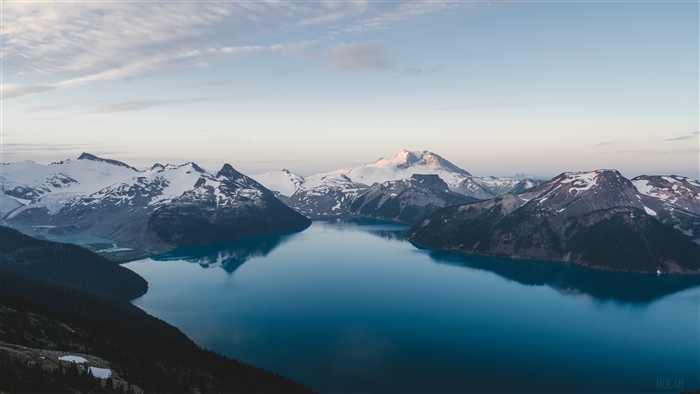 Snow-capped mountains and a lake at sunrise