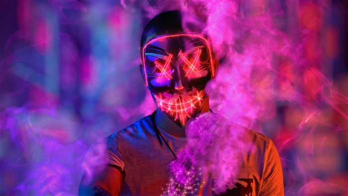 Man wearing Anonymous mask with pink smoke