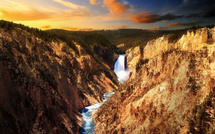 Waterfall in a canyon at sunset