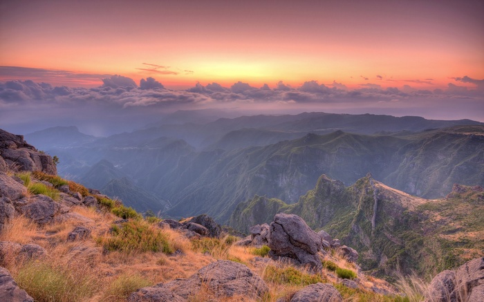 Mountain range at sunset with clouds