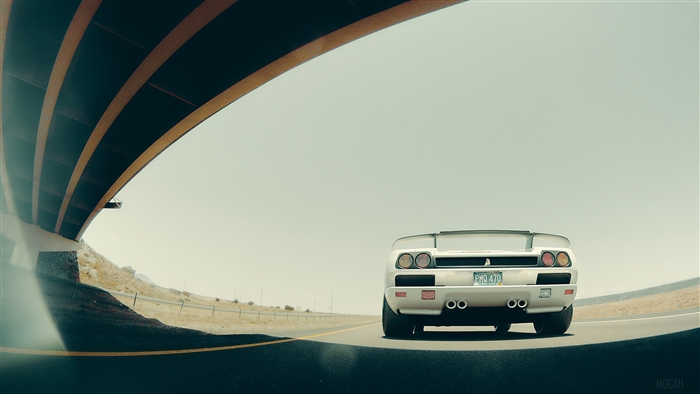 Lamborghini Diablo driving under a bridge