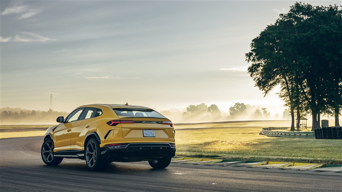 Yellow Lamborghini Urus on a Racetrack