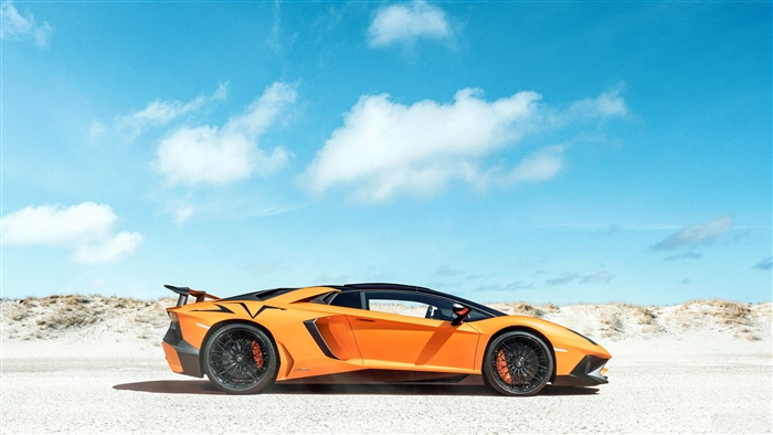 Orange Lamborghini Aventador SVJ on a sandy beach