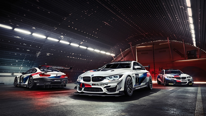 BMW M4 GT4 race cars in a garage