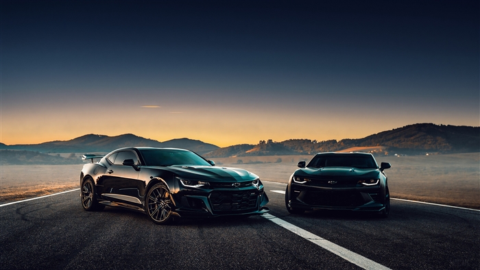 Two Black Chevrolet Camaros on a Road at Sunset 4K