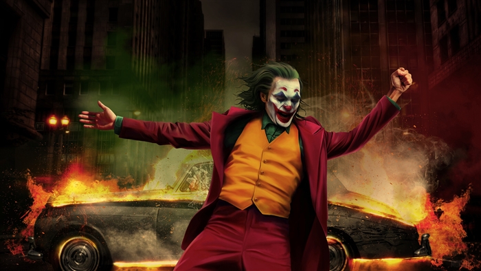 Joker dancing in front of a burning car