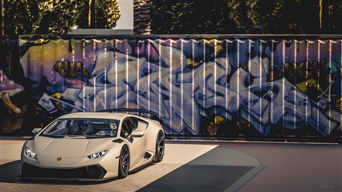 White Lamborghini Huracan in front of graffiti wall