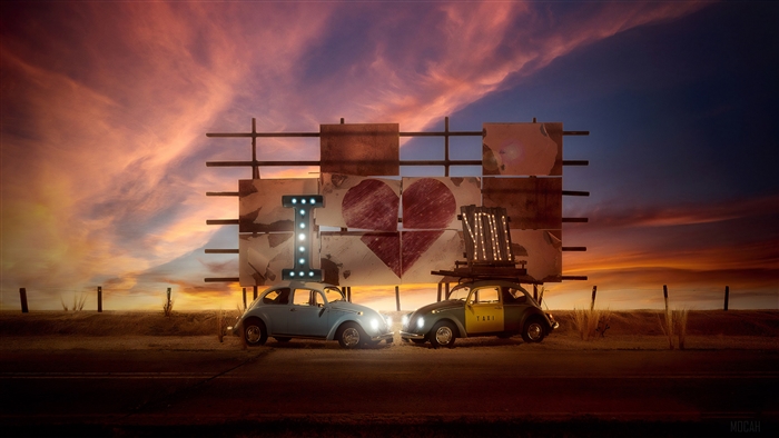 Volkswagen Beetles at a Billboard at Sunset