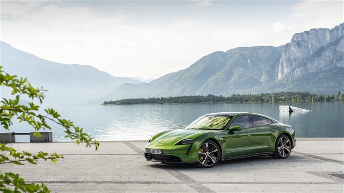Green Porsche Taycan Turbo S by a lake
