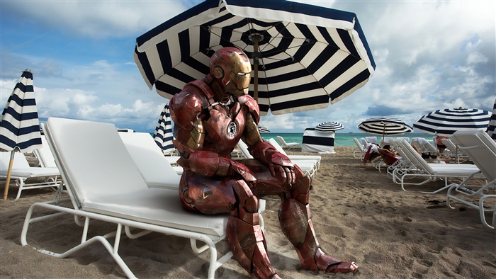 Iron Man on a beach with umbrellas
