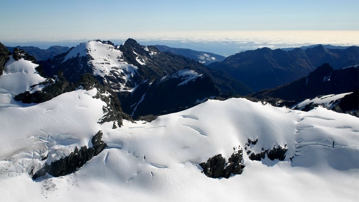 Snow-covered mountains under a clear sky