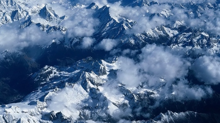 Aerial view of snow-covered mountains and clouds