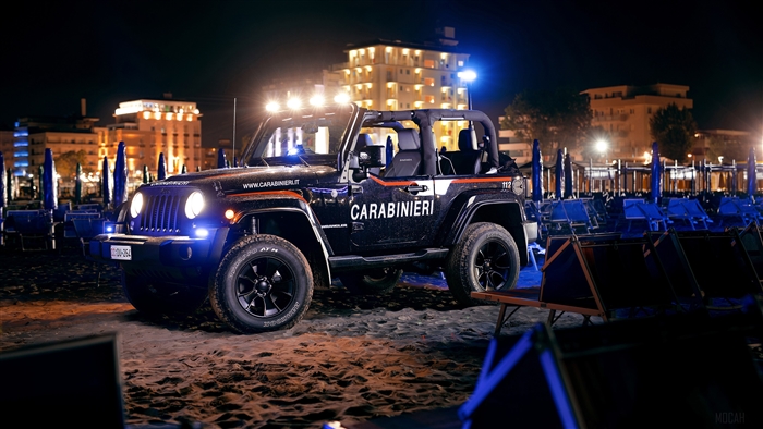 Carabinieri Jeep Wrangler on beach at night 4K