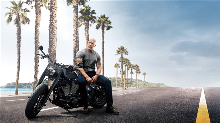Hobbs on a motorcycle with palm trees