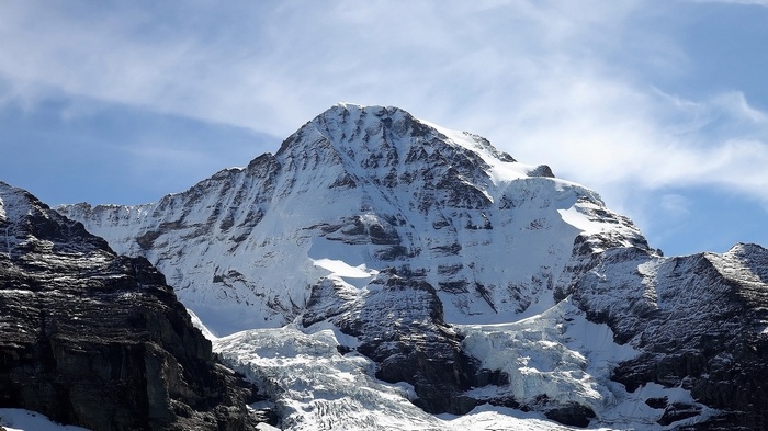 Snow-covered mountain peak under a blue sky
