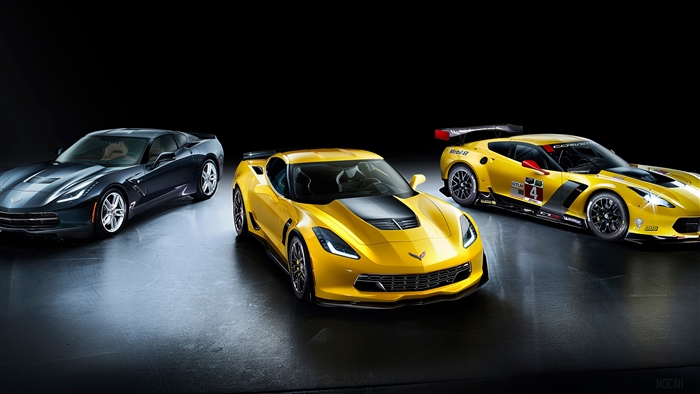 Three Chevrolet Corvettes on a dark background
