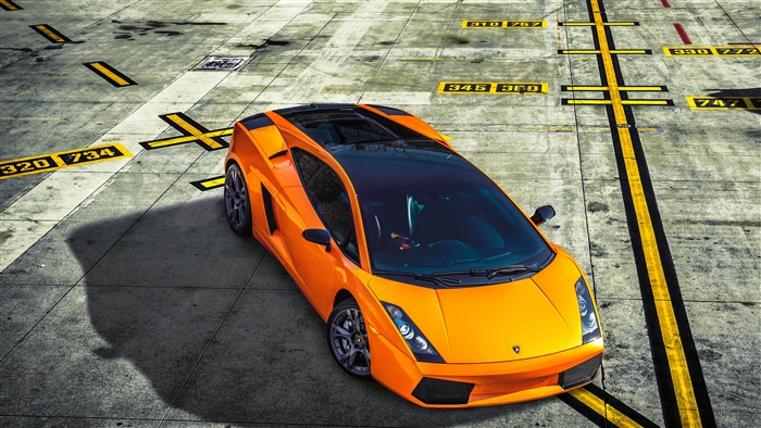 Orange Lamborghini Gallardo on tarmac with markings
