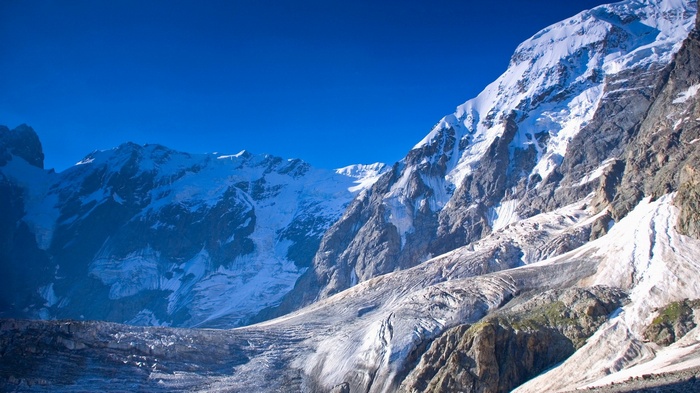 Snow-covered mountains and glacier under a clear blue sky