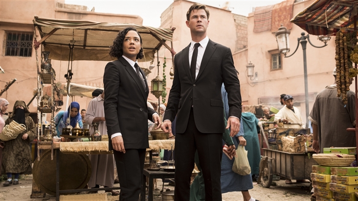 Agents from Men in Black International in a marketplace