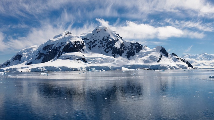 Snow-covered mountains and sea with icebergs