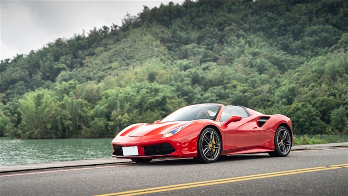 Red Ferrari 488 Spider by a lake