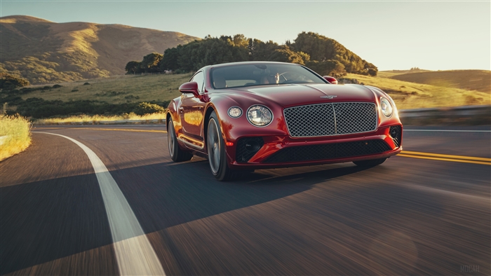Red Bentley Continental GT V8 2020 driving on a road