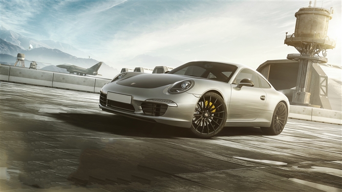 Silver Porsche 911 on a runway with mountains and a jet