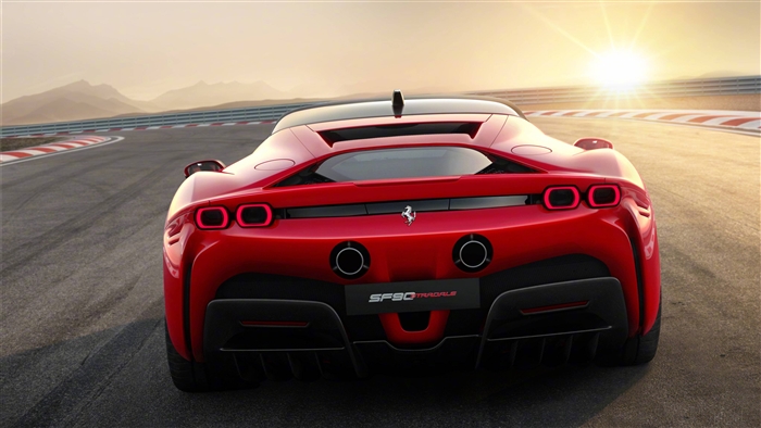 Red Ferrari SF90 Stradale on a race track at sunset