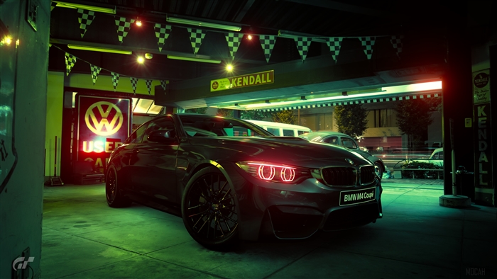 BMW M4 Coupe in a garage with checkered flags