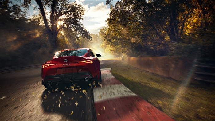 Red Toyota Supra driving on a track