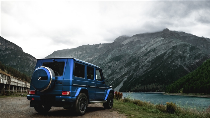 Blue Mercedes-Benz G-Class parked by a lake