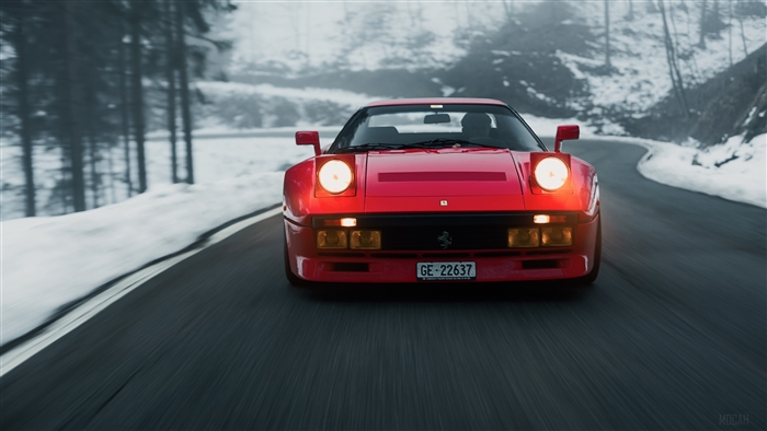 Red Ferrari GTO driving on a snowy road