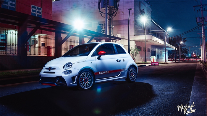 White Fiat 500 Abarth parked on a street at night
