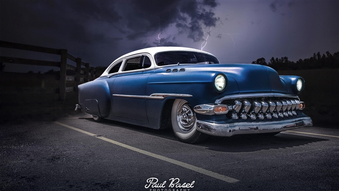 Blue and white classic hot rod car with lightning