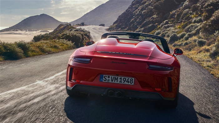 Red Porsche 911 Speedster 2019 driving on coastal road