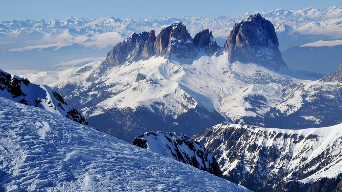 Snow-covered mountains under a clear blue sky