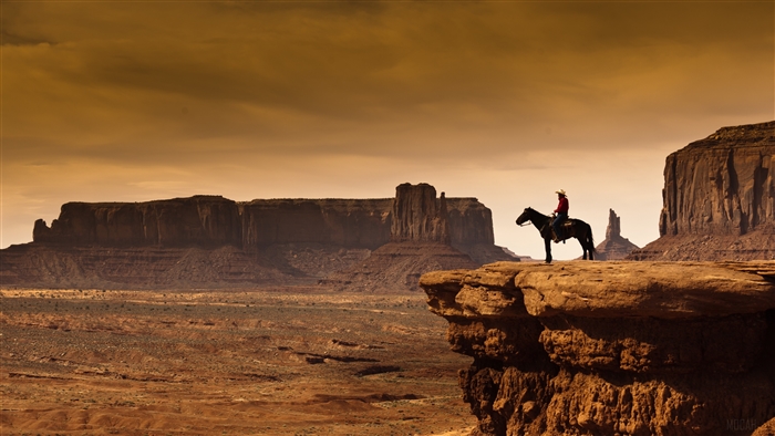 Cowboy on horseback overlooking Monument Valley 4K