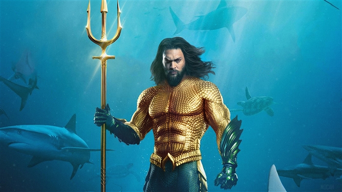 Aquaman holding a trident surrounded by sharks