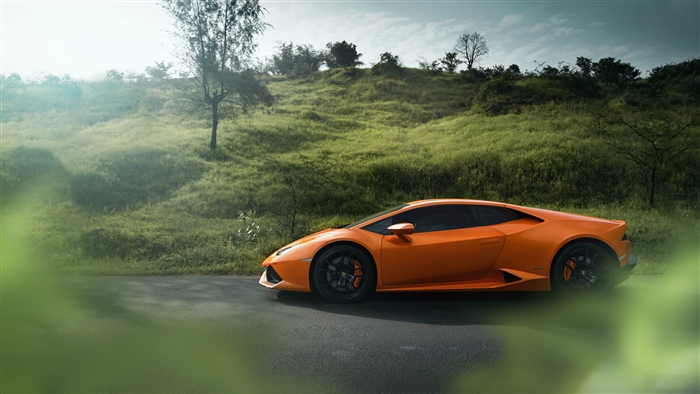 Orange Lamborghini Huracan on a road