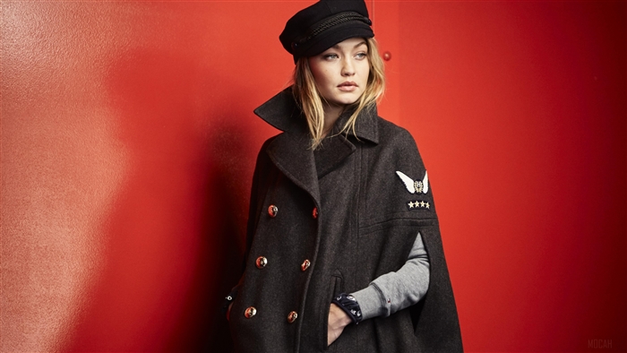 Gigi Hadid in a dark cape and hat