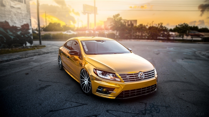 Gold Volkswagen Passat CC with "BID WRAPS" sticker