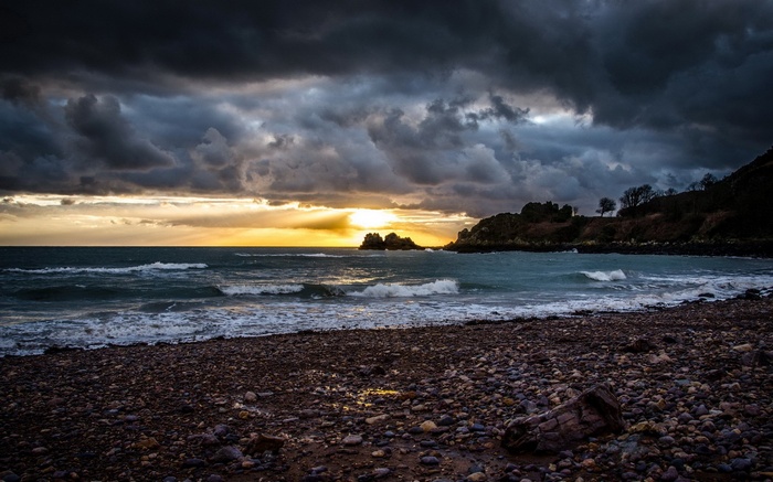 Stormy sunset over a rocky beach and ocean