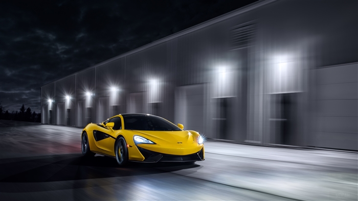 Yellow McLaren 570S driving at night