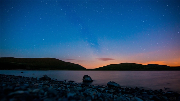 Pebble Coastline Under Starry Night Sky 4K